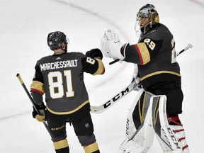 Vegas Golden Knights center Jonathan Marchessault, left, celebrates with goaltender Marc-Andre Fleury after the teams 4-2 win against the Winnipeg Jets during Game 3 of the NHL hockey playoffs Western Conference finals Wednesday, May 16, 2018, in Las Vegas. (AP Photo/David Becker)