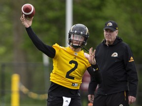 The newest addition to the CFL Hamilton Tiger-Cats roster, quarterback Johnny Manziel (2) is seen with teammates on the field at McMaster University during Tiger Cats training camp in Hamilton, Ont., on Sunday, May 20, 2018. (THE CANADIAN PRESS/Peter Power)