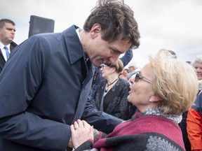 Prime Minister Justin Trudeau greets former mayor Colette Roy-Laroche during an announcement Friday, May 11, 2018 in Lac-Megantic, Que.