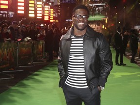 FILE - In this Dec. 7, 2017 file photo, Kevin Hart poses for photographers upon arrival at premiere of the film 'Jumanji, Welcome To The Jungle' in London.  Hart's private jet blew a tire landing at Boston's Logan Airport on Thursday, May 3, 2018.  In a Snapchat video, Hart said it "fishtailed like crazy." The 38-year-old said "I got real angels on my back."(Photo by Joel C Ryan/Invision/AP, File