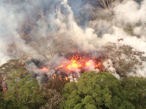 This image released by the U.S. Geological Survey on May 17, 2018 shows lava spattering  from an area between fissures 16 and 20 at 8:20 a.m. HST from the Kilauea Volcano on May 16, 2018.  (AFP PHOTO / US Geological Survey/HO)