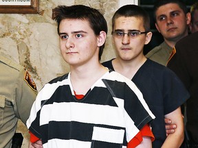 In this Tuesday, Feb. 23, 2016 file photo, Robert Bever, second from left, and Michael Bever, third from left, are escorted into a courtroom for a hearing in Tulsa, Okla. The two Oklahoma teenage brothers are charged with fatally stabbing their parents and three of their younger siblings. (AP)