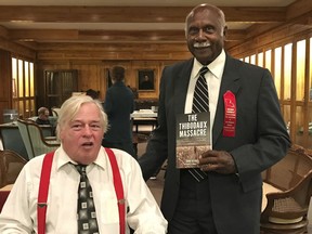 In this Nov. 13, 2016, file photo, provided by John DeSantis, author of "The Thibodaux Massacre: Racial Violence and the 1887 Sugar Cane Labor Strike" poses with Sylvester Jackson, right, great-grandson of massacre survivor Jack Conrad, at the Nicholls State University archives in Thibodaux, La. A patch of ground in southern Louisiana is being surveyed to see if it may hold a mass grave from a Reconstruction-era racial massacre. (AP)