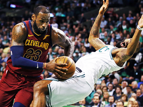 Cleveland Cavaliers forward LeBron James (23) drives against the defense of Boston Celtics forward Marcus Morris during the first quarter of Game 1 of the NBA basketball Eastern Conference Finals, Sunday, May 13, 2018, in Boston. (AP Photo/Michael Dwyer)