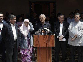 Malaysia's Prime Minister Mahathir Mohamad, centre, speaks next to his opposition alliance leaders during a press conference in Kuala Lumpur, Friday, May 11, 2018.
