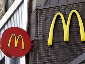 In this April 24, 2017, file photo, corporate signage hangs at a McDonald's restaurant in downtown Pittsburgh.