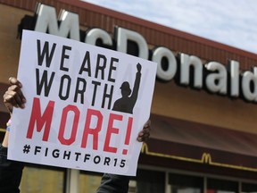 In this April 15, 2015, file photo, McDonald's workers and supporters rally outside a McDonald's in Chicago. On Tuesday, May 22, 2018, Fight for $15 is announcing that it's helping women in several U.S. cities to file complaints with the U.S. Equal Employment Opportunity Commission alleged they experienced sexual harassment while working at McDonald's.
