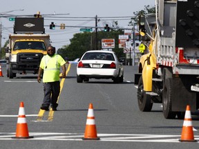 An emergency vehicle passes a roadblock near a scene where a Baltimore County police officer died, while investigating a suspicious vehicle, Monday, May 21, 2018, in Perry Hall, Md.