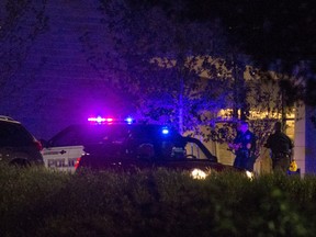 Leawood police investigate the scene after two people were shot in the parking lot of the Church of the Resurrection following Center School District's graduation ceremony, in Leawood, Kansas on Thursday, May 17, 2018. (Shane Keyser /The Kansas City Star via AP)