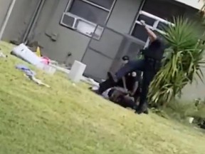 A screengrab from a video posted Thursday, May 3, 2018 shows a Miami officer kicking the head of a handcuffed suspect.