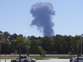 Smoke rises in the distant where an Air National Guard C-130 cargo plane crashed near an in Savannah, Ga., Wednesday, May 2, 2018, in this view from Pooler, Ga.