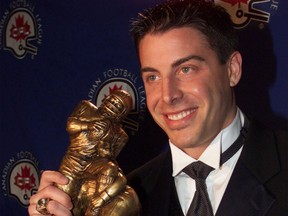 Hamilton Tiger-Cats slotback Mike Morreale holds the trophy after winning the CFL's Tom Pate Memorial Award for community service at the league's awards ceremony in Calgary on Nov. 24, 2000