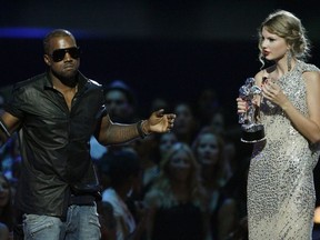 FILE - In this Sept. 13, 2009 file photo, singer Kanye West takes the microphone from singer Taylor Swift as she accepts the "Best Female Video" award during the MTV Video Music Awards in New York. West ranted about how Beyonce was more deserving of the award. Producers dealt with West, who left the venue, and convinced Beyonce to stick around and later escort Swift back out onstage to conclude her speech.