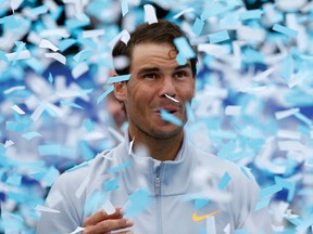 In this April 29, 2018 file photo, Spain's Rafael Nadal reacts to falling confetti after winning the Barcelona Open Tennis Tournament final in Barcelona