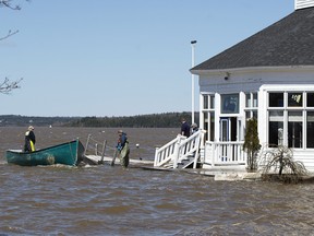 Sailors prepare to secure a work boat at the Royal Kennebecasis Yacht Club in Saint John, N.B. on Saturday, May 5, 2018. Swollen rivers across New Brunswick are still rising, flooding streets and properties and forcing people from their homes in several communities. THE CANADIAN PRESS/Andrew Vaughan
