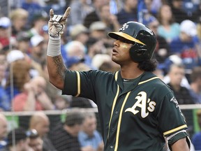 Oakland Athletics designated hitter Khris Davis (2) celebrates his two-run home run during AL action against the Blue Jays in Toronto on Thursday, May 17, 2018. (THE CANADIAN PRESS/Nathan Denette)