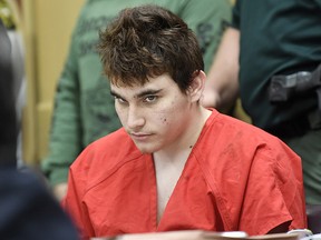 In this Friday, April 27, 2018, file photo, Florida school shooting suspect Nikolas Cruz looks up while in court for a hearing in Fort Lauderdale, Fla.  (Taimy Alvarez/South Florida Sun-Sentinel via AP, Pool, File)