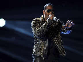 FILE - In this June 30, 2013, file photo, R. Kelly performs onstage at the BET Awards at the Nokia Theatre in Los Angeles. Spotify has removed R. Kelly's music from its playlists, citing its new policy on hate content and hateful conduct.