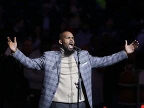 In this Nov. 17, 2015, file photo, musical artist R. Kelly performs the national anthem before an NBA basketball game between the Brooklyn Nets and the Atlanta Hawks in New York.