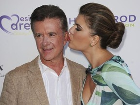 In this Saturday, July 27, 2013 file photo, Alan Thicke, left, and his wife, Tanya Callau, arrive at the 15th Annual DesignCare in Malibu, Calif.
