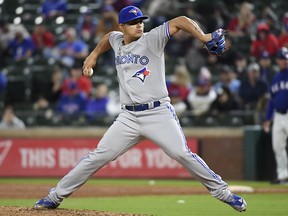 In this April 6, 2018, file photo, Toronto Blue Jays relief pitcher Roberto Osuna works against the Texas Rangers in Arlington, Texas. (AP Photo/Jeffrey McWhorter, File)