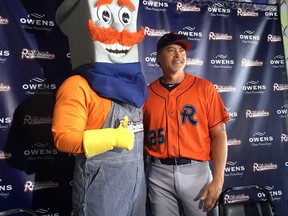 In this May 10, 2018, file photo, the Cleburne Railroaders mascot, Spike, left, poses with former Major League Baseball player and newly-signed player Rafael Palmeiro, right, after a news conference where Palmeiro was introduced in Cleburne, Texas