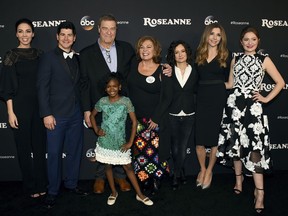 In this March 23, 2018 file photo, from left, Whitney Cummings, Michael Fishman, John Goodman, Jayden Rey, Roseanne Barr, Sara Gilbert, Sarah Chalke and Emma Kenney arrive at the Los Angeles premiere of "Roseanne" in Burbank, Calif.