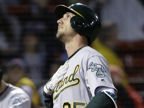 Oakland Athletics' Stephen Piscotty looks up as he arrives at home plate after hitting a home run Tuesday, May 15, 2018, in Boston. (AP Photo/Steven Senne)