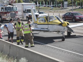 Emergency workers stand next to a plane which had to make an emergency landing on Interstate 15 in Riverdale, Utah on Saturday May, 26, 2018. (Matt Herp/Standard-Examiner via AP)