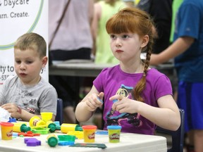 Children play with Play-Doh at Bowes Family Gardens in Revolution Place on May 28, 2017 in Grande Prairie, Alta. (Kevin Hampson/Grande Prairie Daily Herald-Tribune/Postmedia Network)