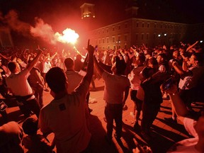 Fans of Warsaw's soccer team Legia Warszawa burn flares as they celebrate their club's victory of the Polish soccer championship in Warsaw, Poland, Sunday, May 20, 2018.