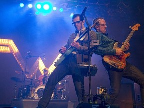 Rivers Cuomo of Weezer, left, joins bassist Scott Shriner, right, at the front of the stage as they rock the crowd at Rock The Park in Harris Park in London on Thursday July 24, 2014. CRAIG GLOVER The London Free Press / Postmedia Network