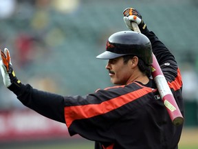 In this Aug. 15, 2005, file photo, Baltimore Orioles' Rafael Palmeiro waves to fans as he prepares to take batting practice in Oakland, Calif.