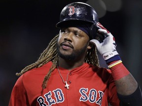 In this Sept. 29, 2017, file photo, Boston Red Sox designated hitter Hanley Ramirez takes off his batting helmet after grounding out with bases loaded during the sixth inning of a baseball game against the Houston Astros, at Fenway Park in Boston.