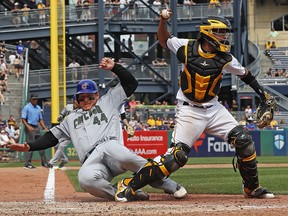 In this Monday, May 28, 2018 photo, Pittsburgh Pirates catcher Elias Diaz throws to first after getting the force out at home plate as Chicago Cubs' Anthony Rizzo slides in hard. (AP Photo/Gene J. Puskar)