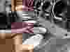 A worker lifts a lunch bowl off the production line at Spyce, a restaurant which uses a robotic cooking process, in Boston, Thursday, May 3, 2018.