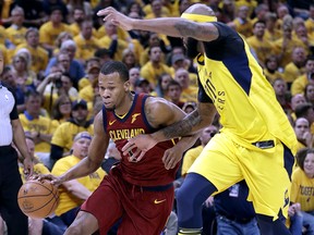 In this April 27, 2018, file photo, Cleveland Cavaliers' Rodney Hood, left, heads to the basket past Indiana Pacers' Trevor Booker in Indianapolis. (AP Photo/Darron Cummings, File)