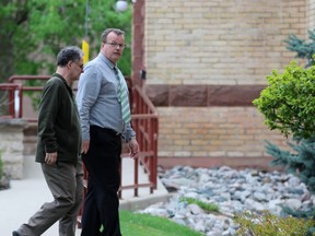John Paul Stone, facing the camera, walks toward the Perth County Courthouse on Thursday, May 10, 2018 in Stratford, Ont.