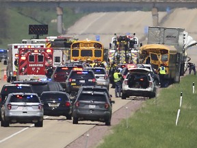 Traffic is stalled as emergency personnel work the scene of an accident between a semi and a school bus on Interstate 39 near Lodi, Wis., Wednesday, May 23, 2018.