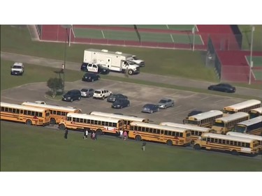 In this image taken from video law enforcement officers respond to a high school near Houston after an active shooter was reported on campus, Friday, May 18, 2018, in Santa Fe, Texas.