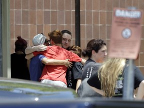 People react outside the unification center at the Alamo Gym, following a shooting at Santa Fe High School Friday, May 18, 2018, in Santa Fe, Texas.