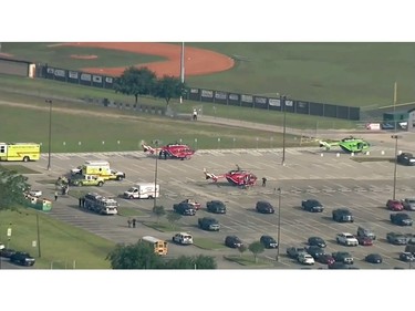 In this image taken from video helicopters sit in the parking lot of Santa Fe High School as law enforcement officers respond to the school near Houston after an active shooter was reported on campus, Friday, May 18, 2018, in Santa Fe, Texas.