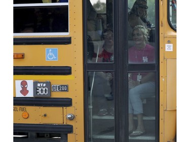 School staff members sit in a school bus to be transported to another school after a shooting at the Santa Fe High School in Santa Fe, Texas, on Friday morning, May 18, 2018.