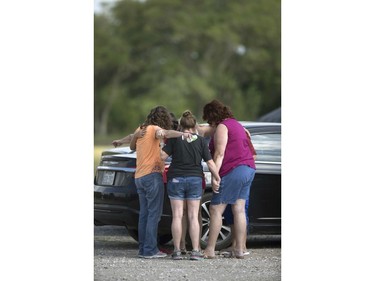 Parents of Santa Fe High School students join in prayer at the parking lot of the Arcadia First Baptist Christian School accompanied by residents after a shooter open fired at the high school, Friday, May 18, 2018, in Santa Fe, Texas.