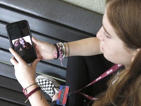 Eden Hebron looks at a photo of Alyssa Alhadeff, while speaking about the shooting at Marjory Stoneman Douglas High School in Parkland, Fla. on April 10, 2018. (AP Photo/Adriana Gomez Licon)