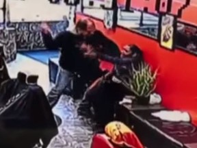 Security footage shows a man allegedly attacking his wife with a screwdriver at a New York barber shop. (YouTube/CBS New York)