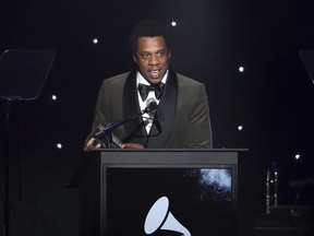 In this Jan. 27, 2018, file photo, honoree Jay-Z speaks onstage at the 2018 Pre-Grammy Gala And Salute To Industry Icons at the Sheraton New York Times Square Hotel in New York.