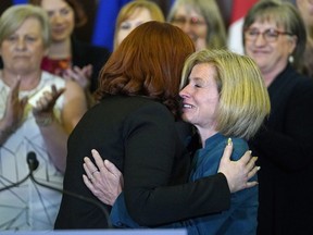 Carlynn McAneeley, a survivor of sexual violence, is hugged by Alberta Premier Rachel Notley at the Alberta Legislature on Tuesday May 1, 2018.