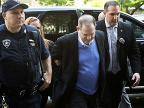 Harvey Weinstein is escorted into court, Friday, May 25, 2018, in New York. Weinstein surrendered Friday to face rape and other charges from encounters with two women.