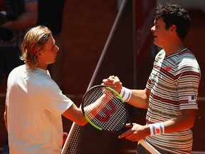 Denis Shapovalov of Canada shakes hands at the net after his straight sets victory against Milos Raonic of Canada in their third round match during day six of the Mutua Madrid Open tennis tournament at the Caja Magica on May 10, 2018
